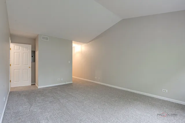 a view of an empty room and closet area