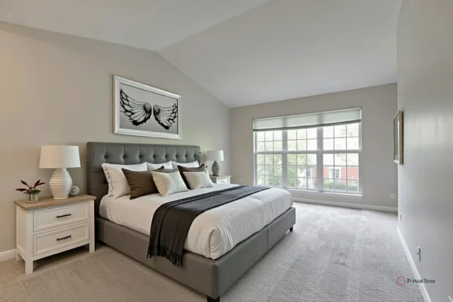 a spacious bedroom with a bed and a large window