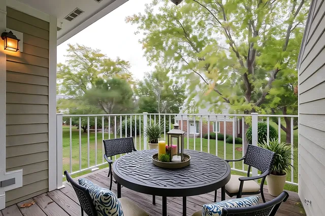 a view of a deck with a chair and dining table