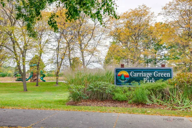 a view of street sign under a large tree