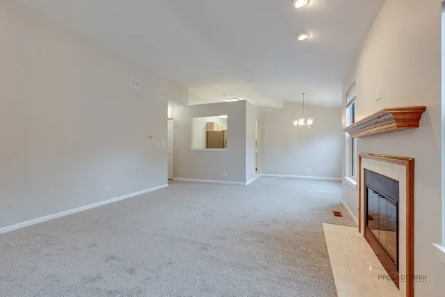 a view of an empty room and a fireplace