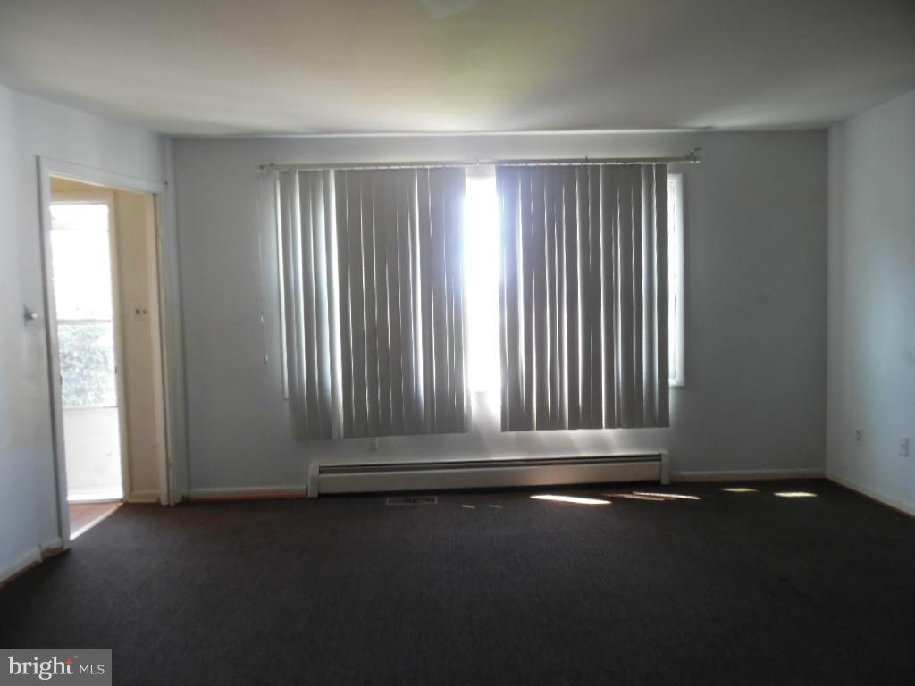 6914 German Hill Road Baltimore, MD 21222 - Photo 3 of 28 an empty room with wooden floor and a window