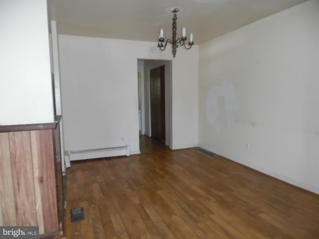 6914 German Hill Road Baltimore, MD 21222 - Photo 4 of 28 a view of a hallway with wooden floor and chandelier