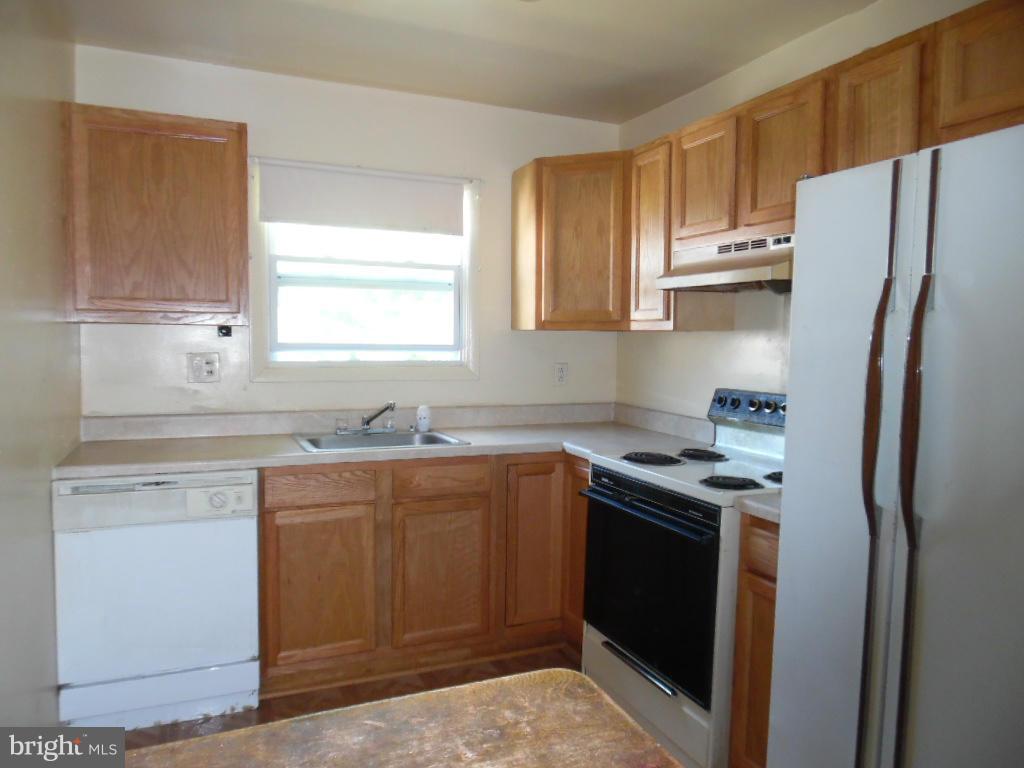 6914 German Hill Road Baltimore, MD 21222 - Photo 6 of 28 a kitchen with stainless steel appliances granite countertop a refrigerator stove sink and cabinets