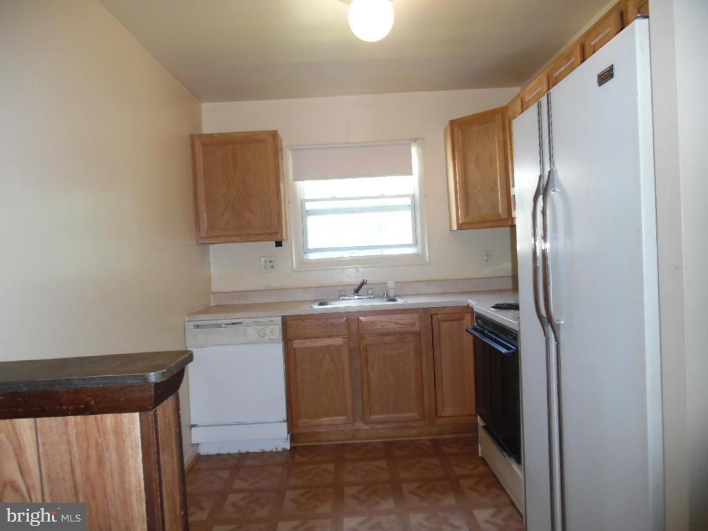 6914 German Hill Road Baltimore, MD 21222 - Photo 8 of 28 a kitchen with a refrigerator sink and window