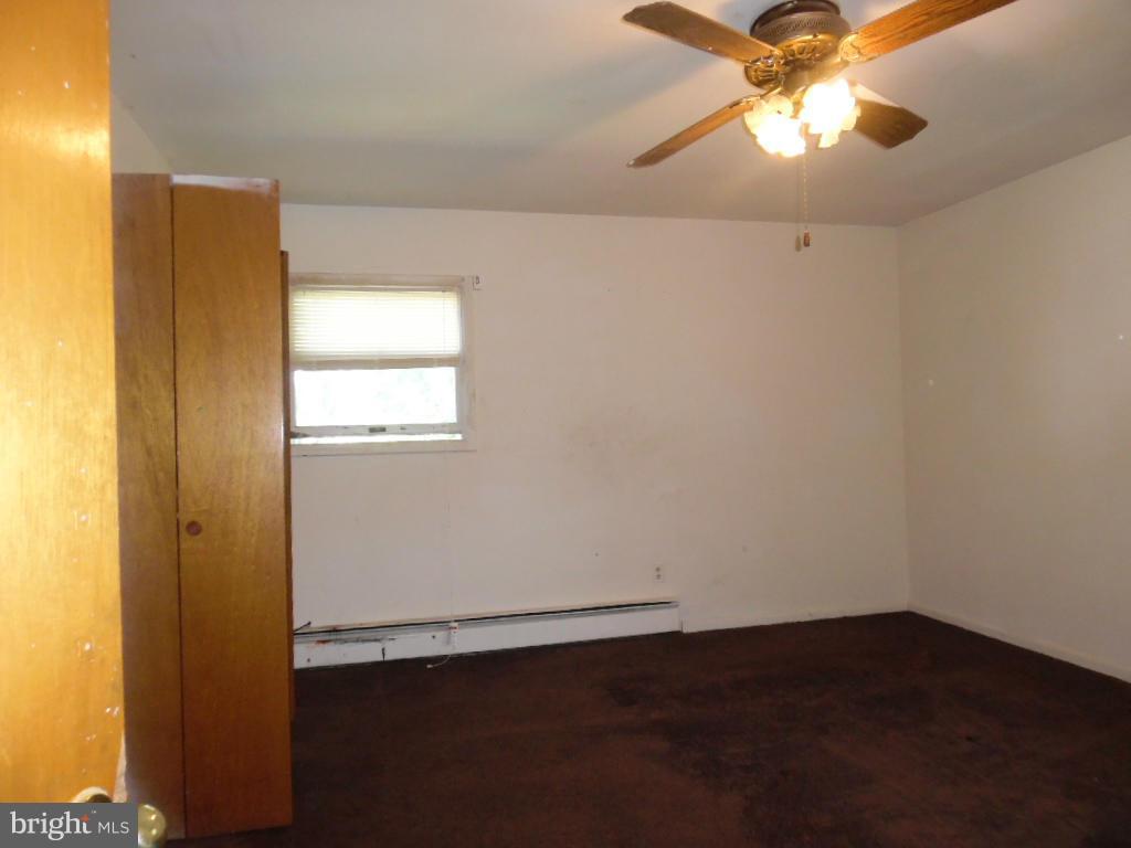6914 German Hill Road Baltimore, MD 21222 - Photo 9 of 28 an empty room with a window and a chandelier fan