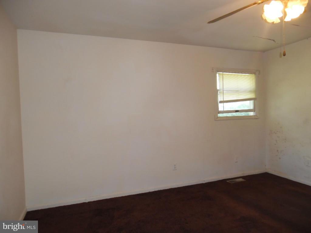 6914 German Hill Road Baltimore, MD 21222 - Photo 10 of 28 an empty room with wooden floor and windows