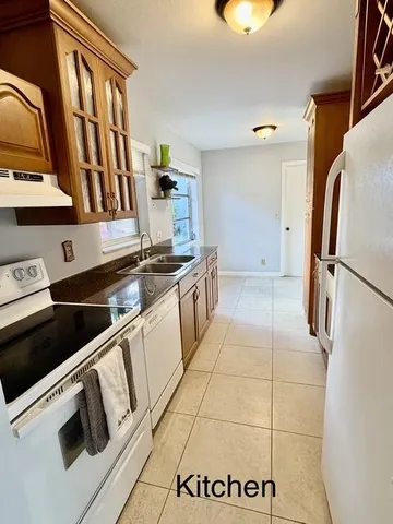 a kitchen with stainless steel appliances granite countertop a refrigerator and a stove
