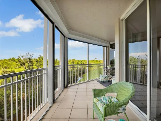 a balcony with furniture and a potted plant