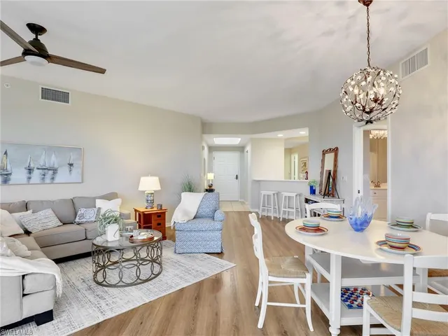 a living room with furniture a chandelier and a table