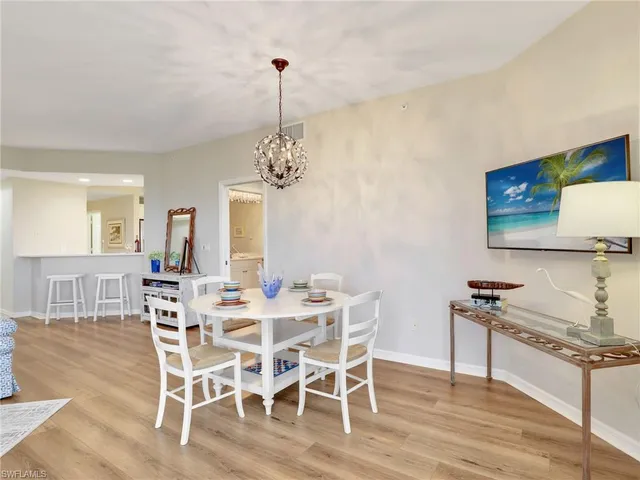 a view of a dining room with furniture wooden floor and chandelier