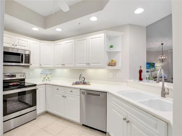 a kitchen with a sink stove and microwave