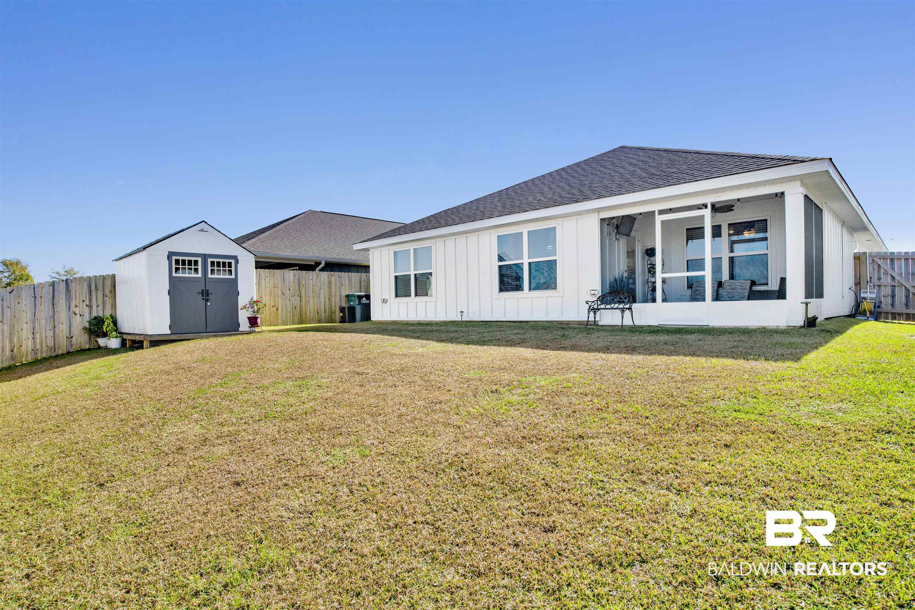 8102 Irwin Loop Daphne, AL 36526 - Photo 27 of 30 Rear view of house featuring a shed, ceiling fan, and a lawn