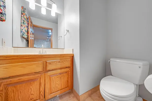 a white toilet sitting next to a bathroom