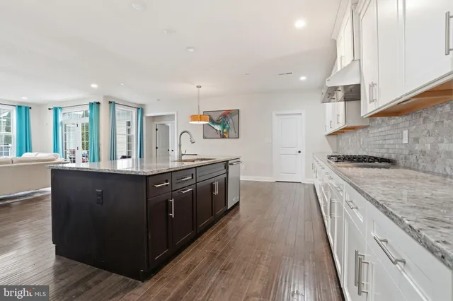 a kitchen with stainless steel appliances granite countertop a stove and a sink