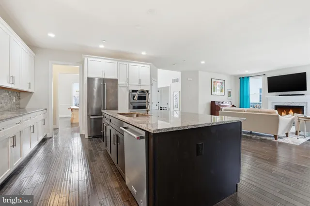 a kitchen with stainless steel appliances a sink stove and refrigerator