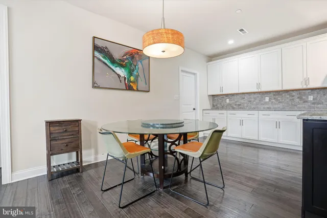 a view of a dining room with furniture wooden floor and chandelier