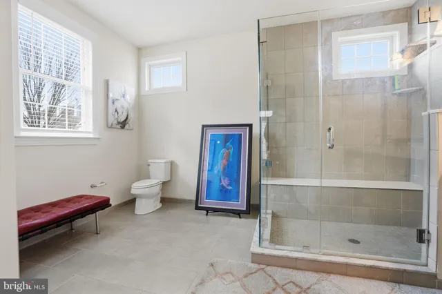 a bathroom with a toilet sink and shower