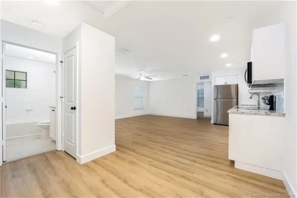 a view of kitchen with furniture and refrigerator