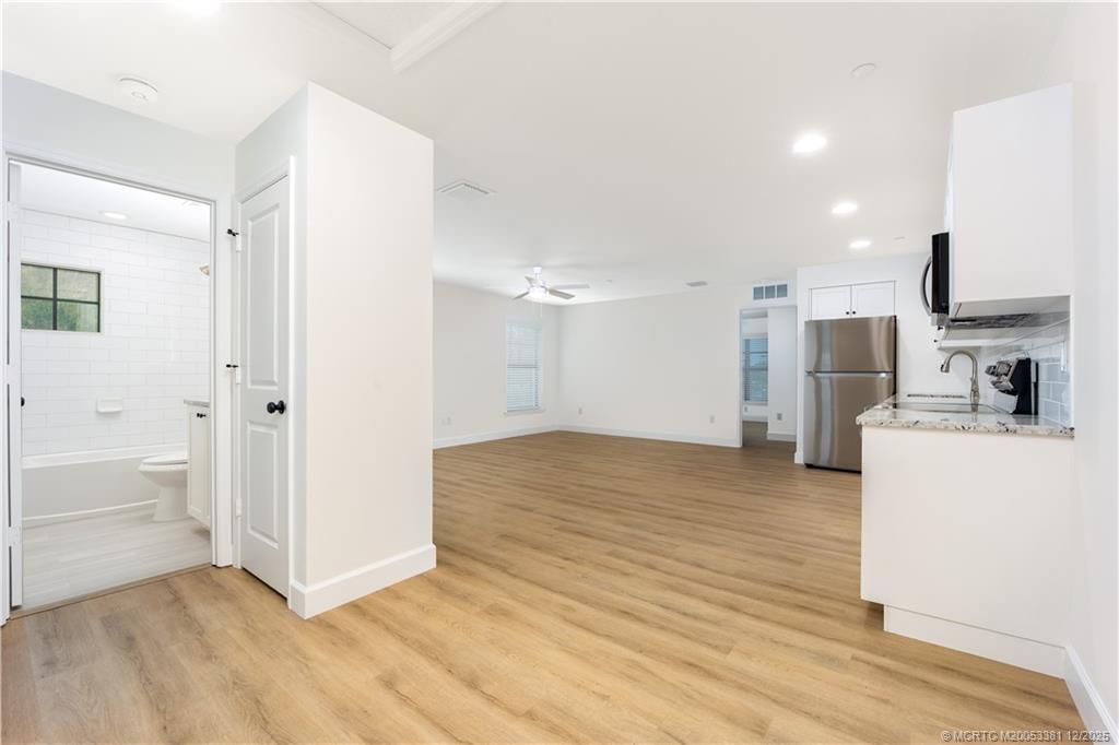 a view of kitchen with furniture and refrigerator