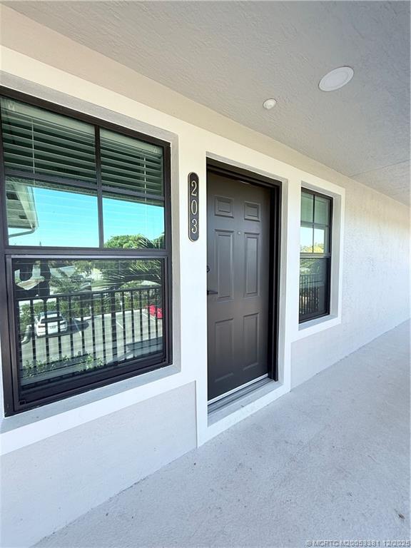 3375 Southwest Mapp Road, Unit 203 Palm City, FL 34990 - Photo 19 of 22 a view of porch with a table and chair
