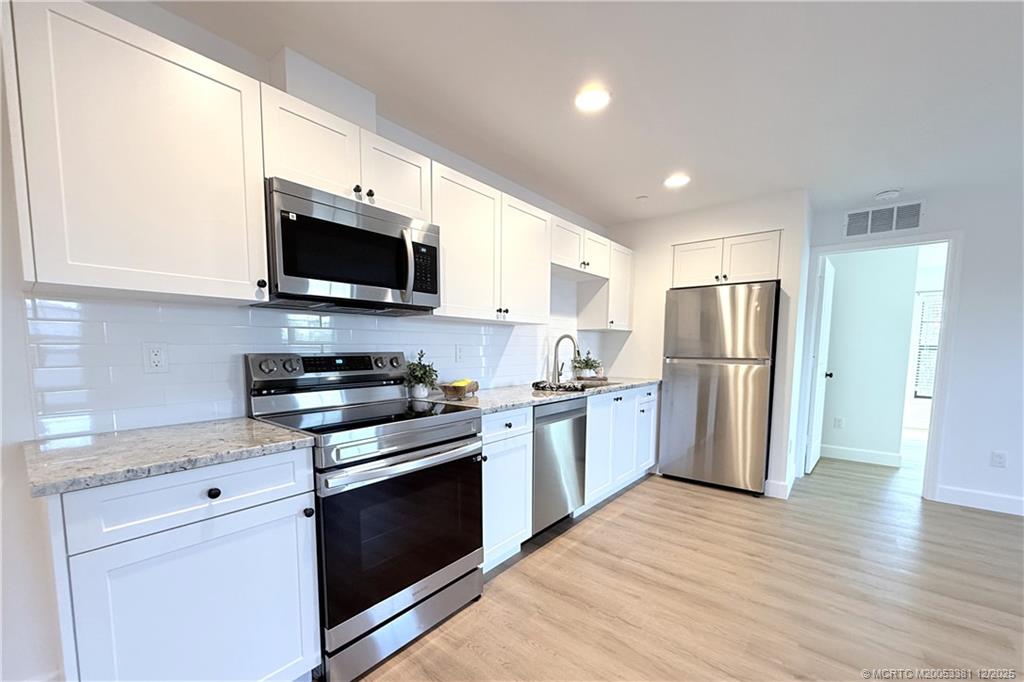 3375 Southwest Mapp Road, Unit 203 Palm City, FL 34990 - Photo 3 of 22 a kitchen with a refrigerator stove and microwave