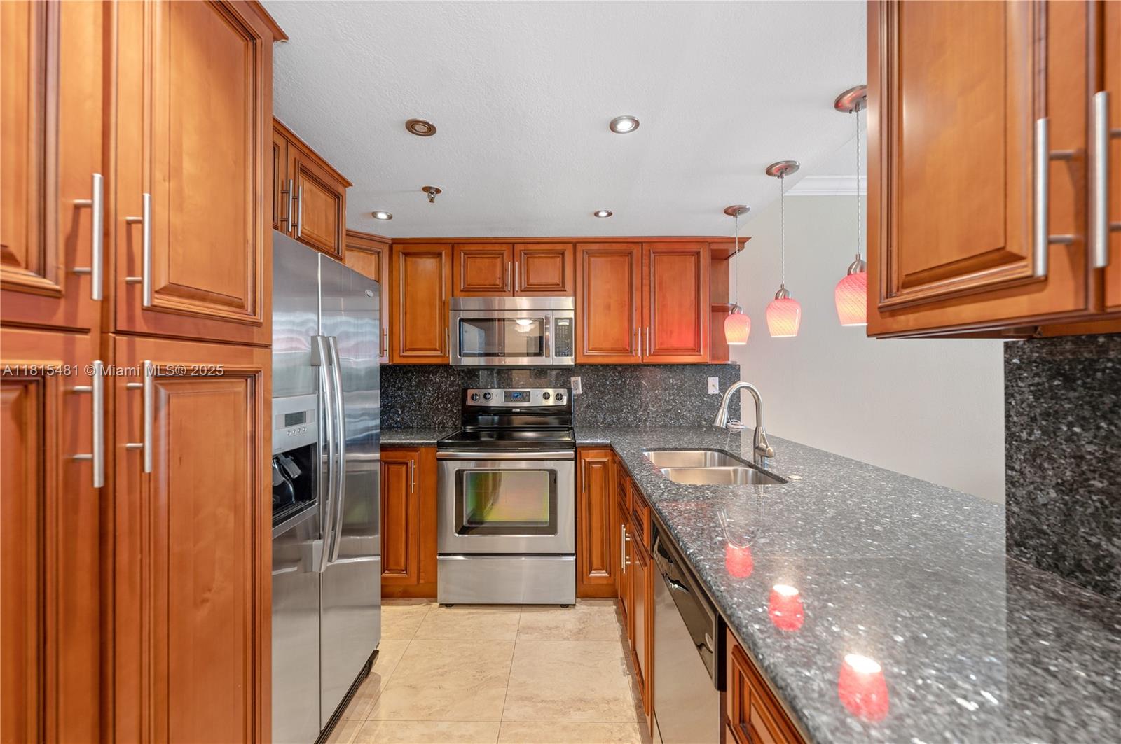 540 Brickell Key Drive, Unit 600 Miami, FL 33131 - Photo 2 of 28 a kitchen with stainless steel appliances granite countertop a sink a stove and a refrigerator
