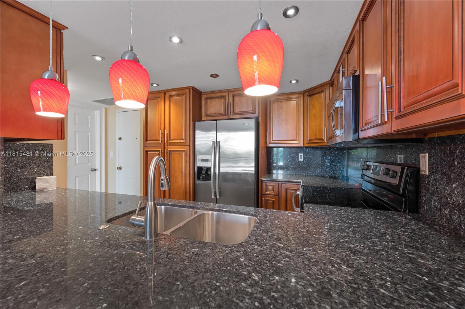540 Brickell Key Drive, Unit 600 Miami, FL 33131 - Photo 4 of 28 a kitchen with granite countertop a stove a sink and a refrigerator