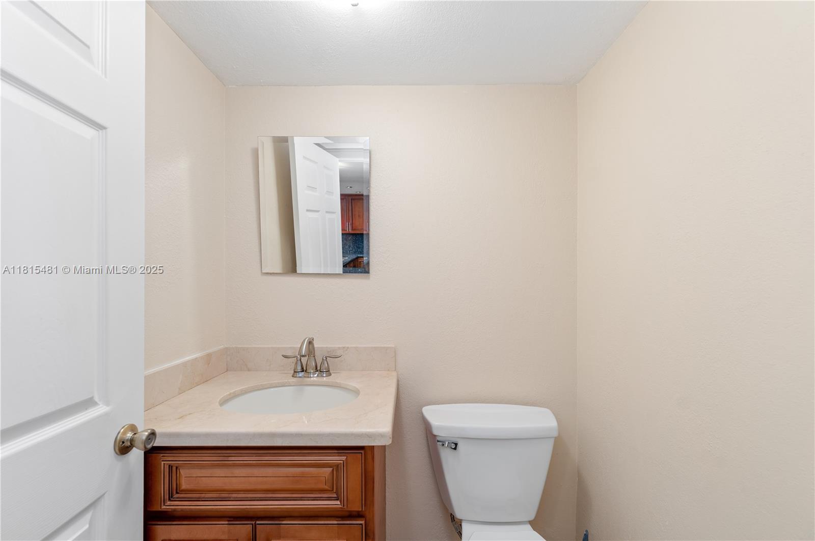 540 Brickell Key Drive, Unit 600 Miami, FL 33131 - Photo 9 of 28 a bathroom with a sink a toilet and a mirror