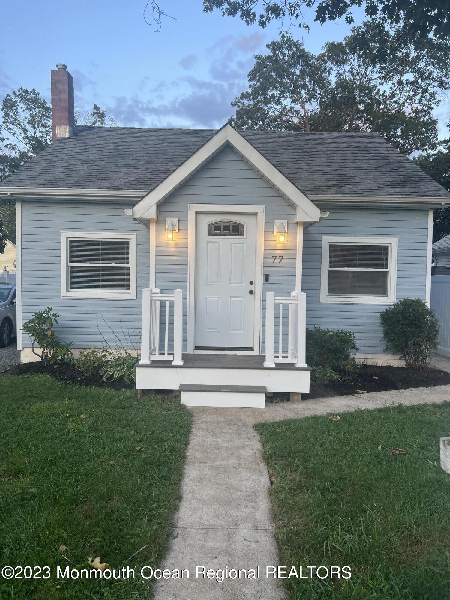 77 London Road Brick, NJ 08723 - Photo 3 of 10 a front view of a house with a yard and garage