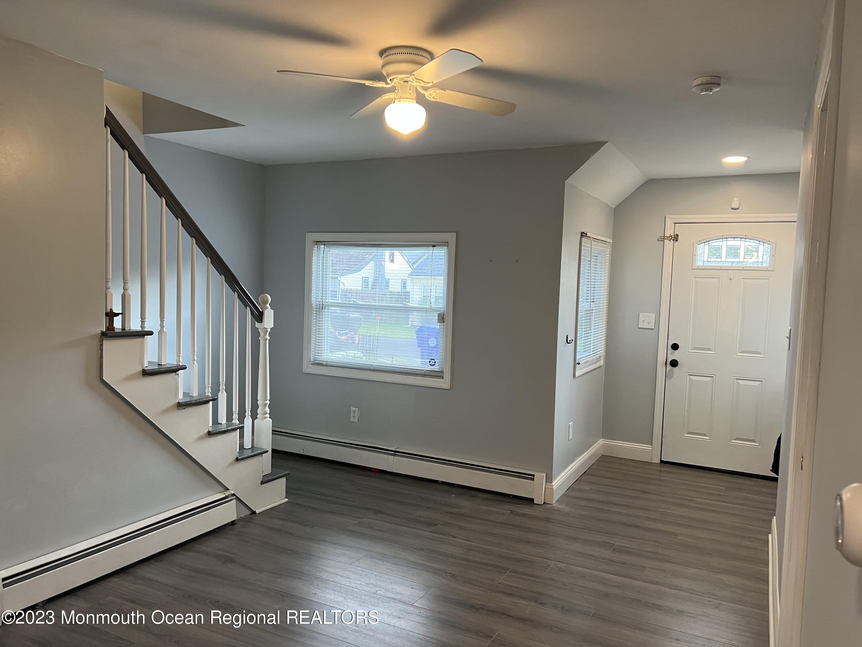 77 London Road Brick, NJ 08723 - Photo 5 of 10 a view of an empty room with wooden floor and a ceiling fan