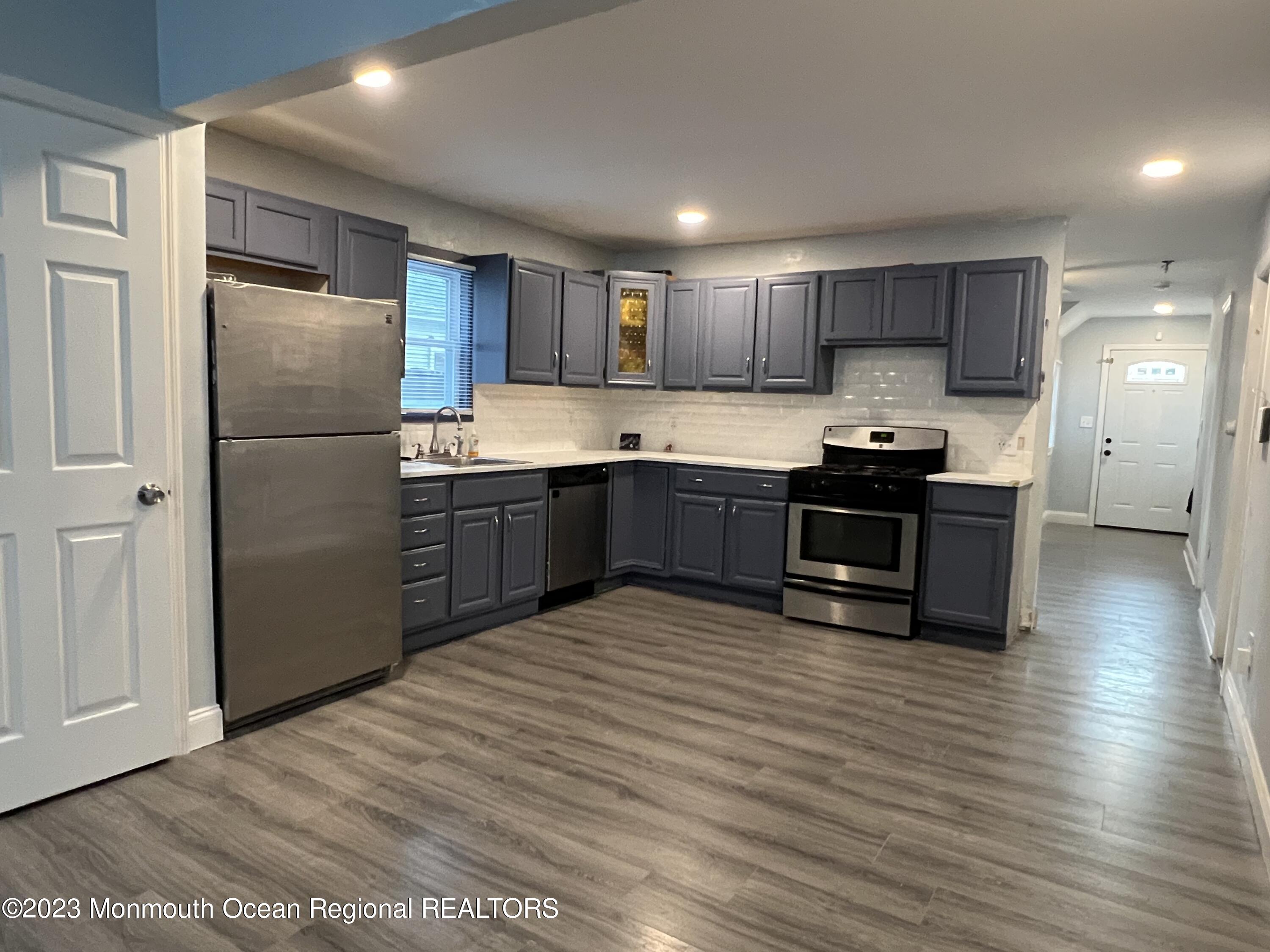 77 London Road Brick, NJ 08723 - Photo 7 of 10 a kitchen with stainless steel appliances granite countertop a refrigerator a sink a stove and cabinets