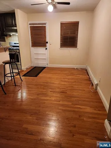 a view of a livingroom with furniture wooden floor and window