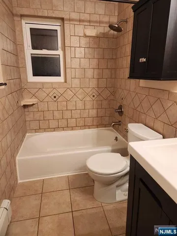 a bathroom with a sink a toilet and bathtub