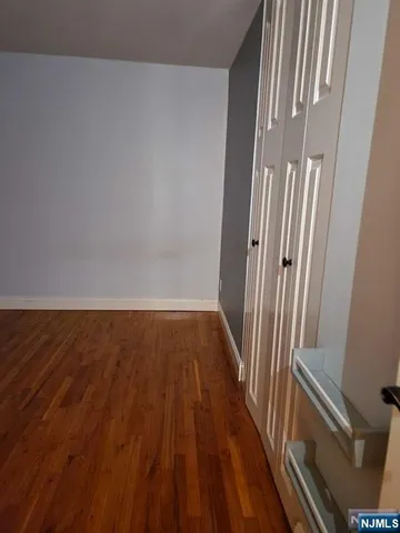 a view of a room with wooden floor and staircase