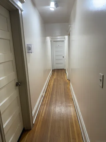 a view of wooden floor in a hallway