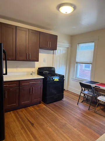 a kitchen with a wooden cabinets and a stove top oven
