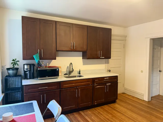 a kitchen with granite countertop wooden cabinets and sink