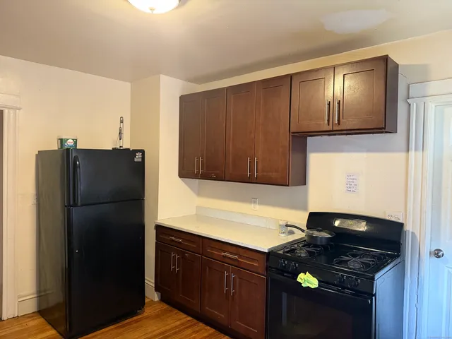 a kitchen with a refrigerator and a stove