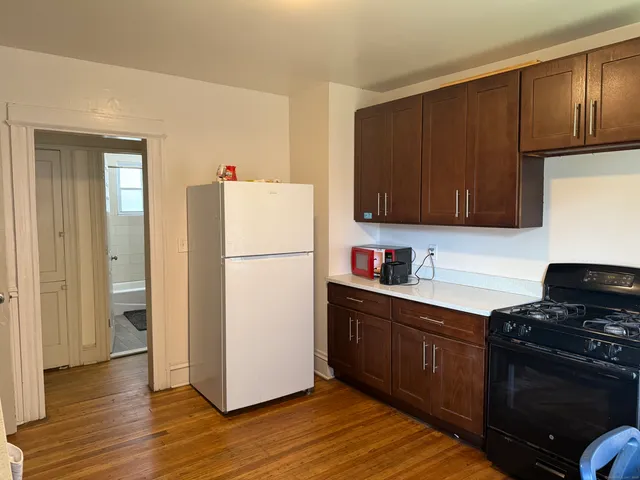 a kitchen with a refrigerator sink and cabinets