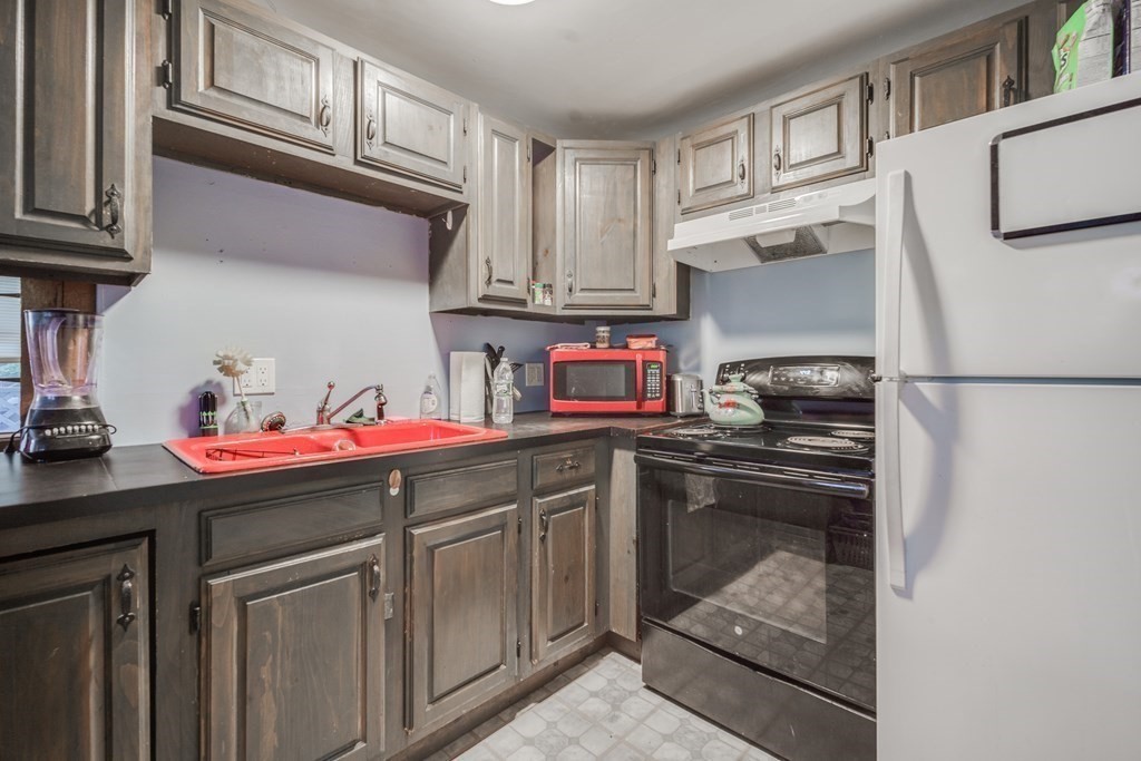 122 Sandisfield Road Sandisfield, MA 01255 - Photo 27 of 41 a kitchen with stainless steel appliances granite countertop a sink stove and cabinets
