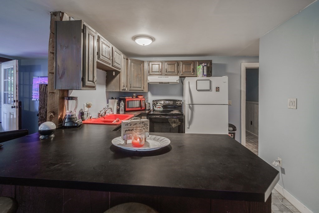 122 Sandisfield Road Sandisfield, MA 01255 - Photo 29 of 41 a kitchen with a table and a stove in it