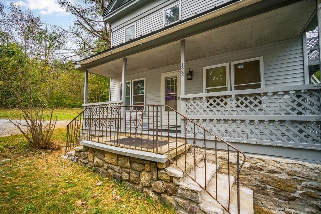 122 Sandisfield Road Sandisfield, MA 01255 - Photo 3 of 41 a view of a house with a small deck and a garden