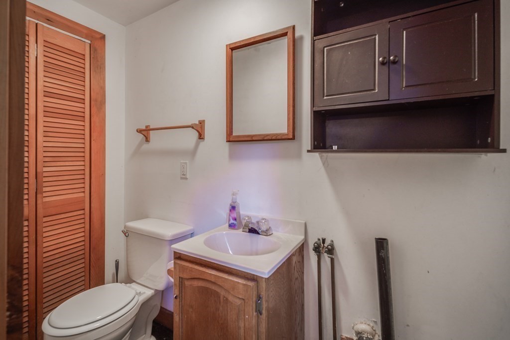 122 Sandisfield Road Sandisfield, MA 01255 - Photo 31 of 41 a bathroom with a sink a toilet and mirror