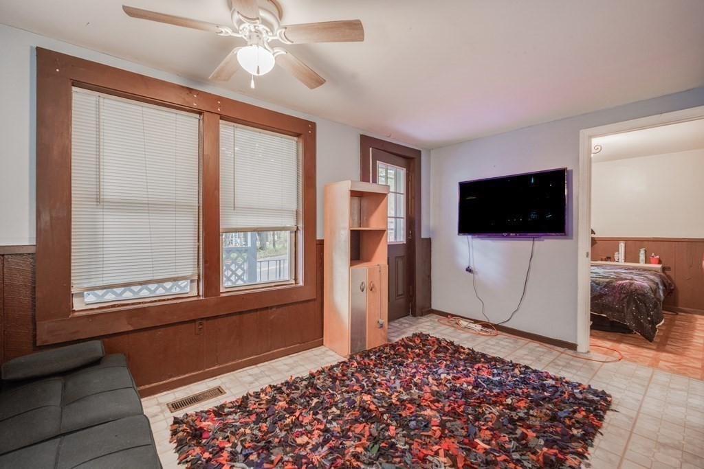 122 Sandisfield Road Sandisfield, MA 01255 - Photo 32 of 41 a living room with a flat screen tv and a window
