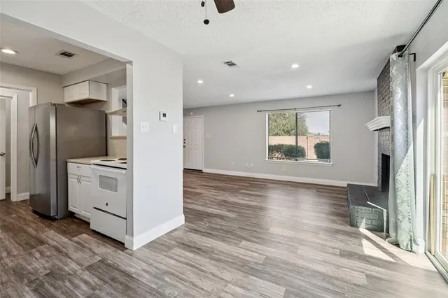 a kitchen with stainless steel appliances a refrigerator sink and cabinets