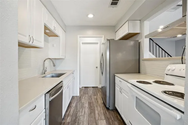 a kitchen with a sink stove and refrigerator