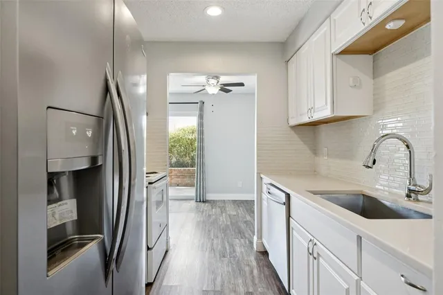 a view of a kitchen with a sink and dishwasher