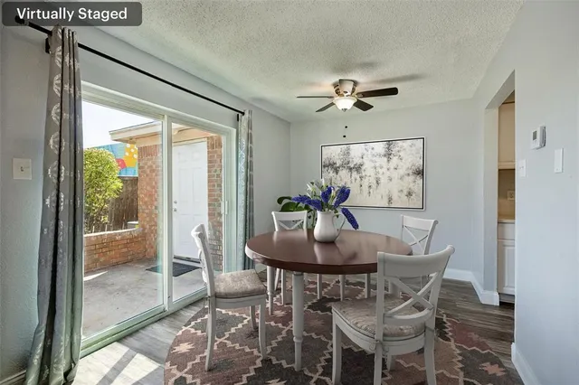 a dining room with furniture a chandelier and wooden floor