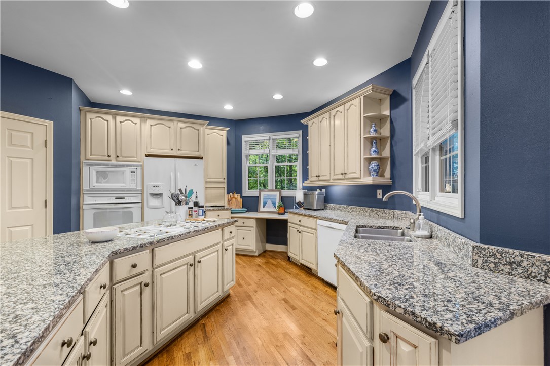 106 Red Maple Way Clemson, SC 29631 - Photo 13 of 49 Gleaming granite countertops pair beautifully with rich wood flooring in this well-appointed kitchen.